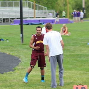 Trey Eaton talks with Drew Davied at the Regional Track Meet in Louisburg. Nine Trojan boys are headed to state in Track.  